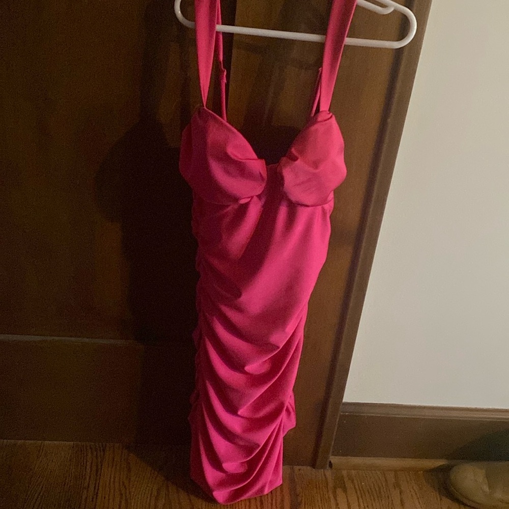 Fitted, Hot pink, stretchy dress with adjustable straps and padded bust. Zip up.